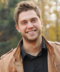Young boy smiling at outside alone