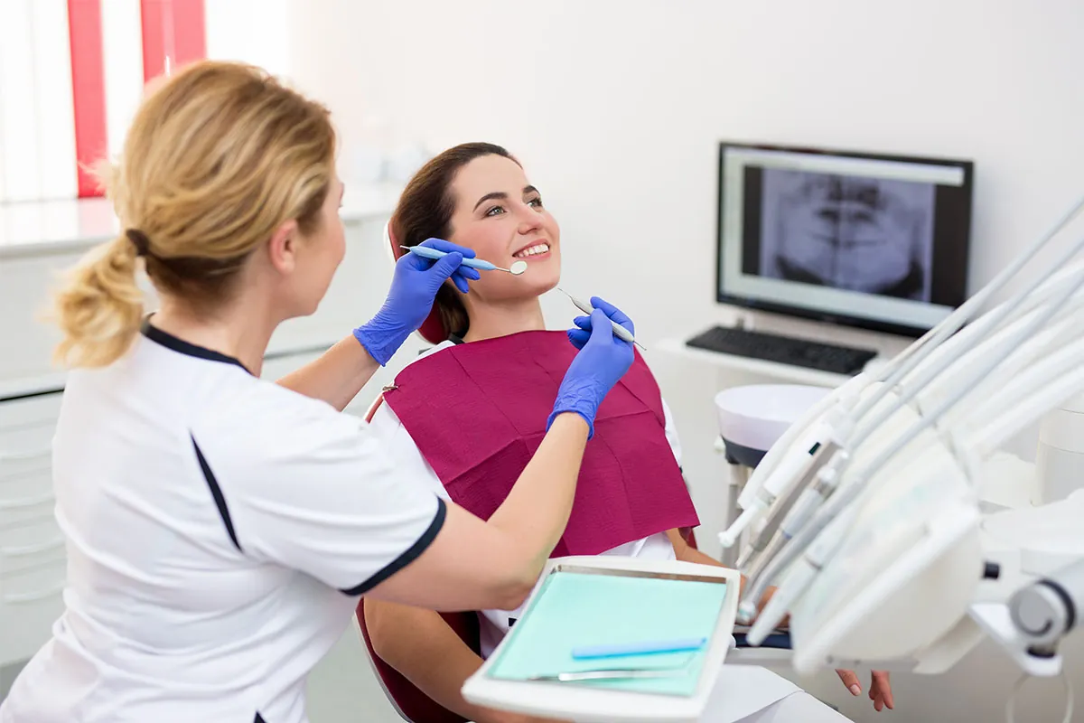 Dentist doing dental checkup for her patient