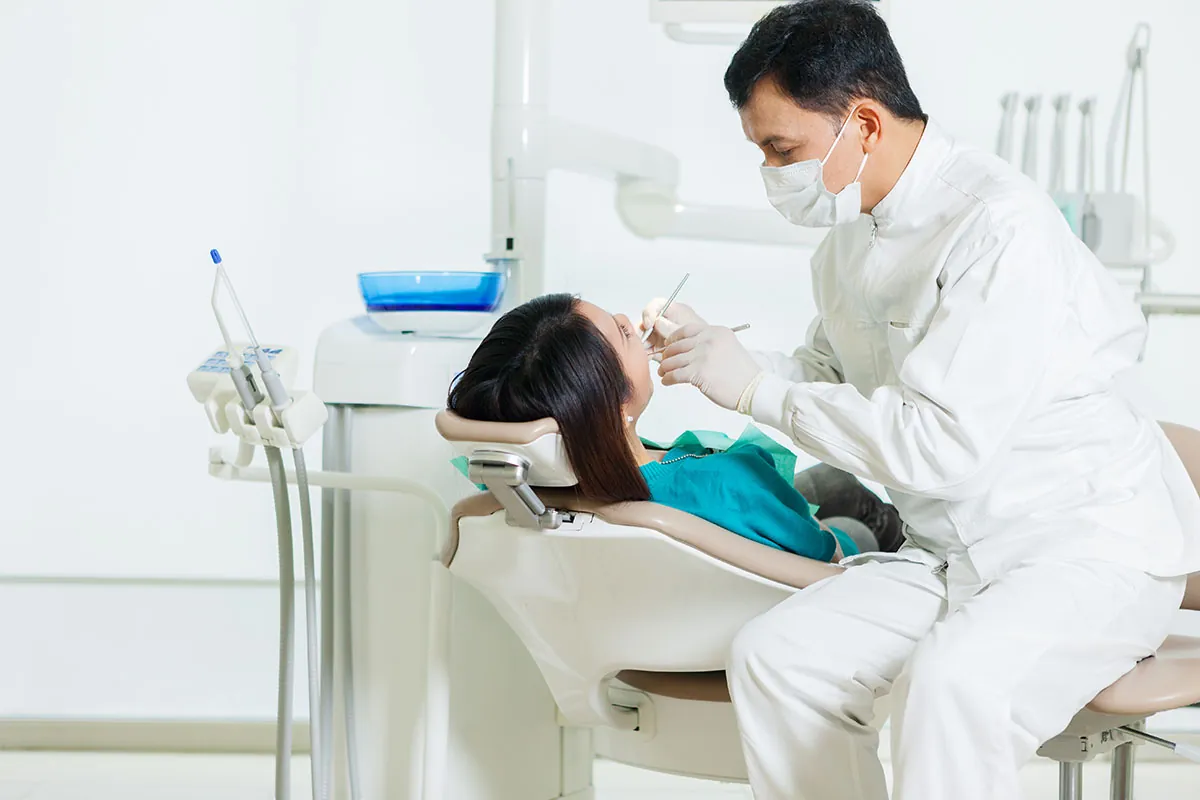Dentist doing dental checkup for his patient