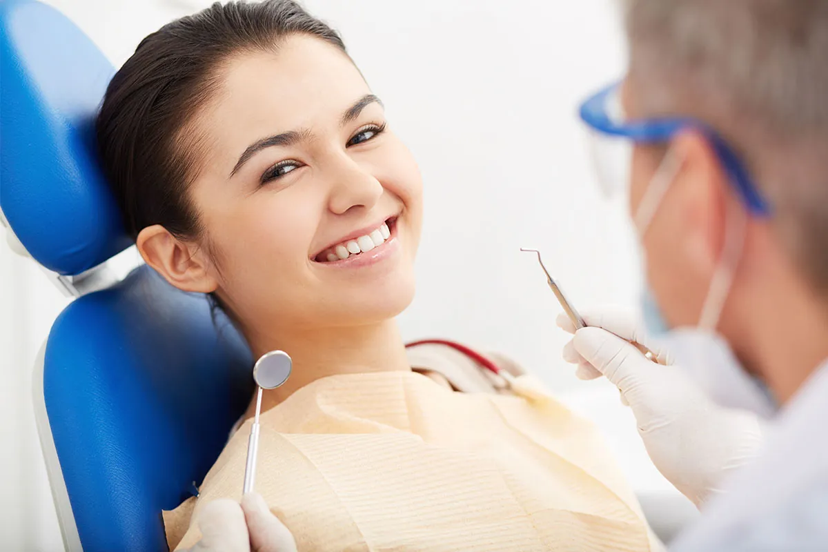 Beautiful woman smiling at dental